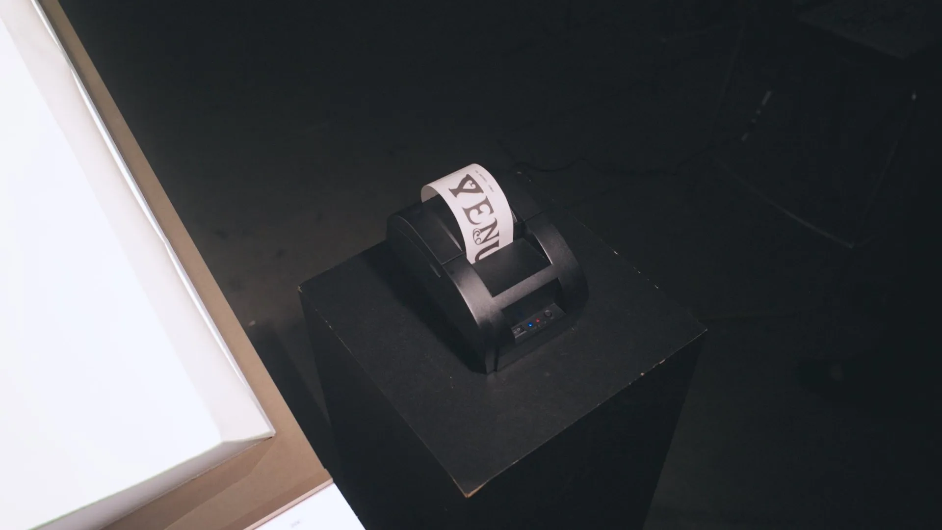 Small receipt printer producing a strip printed with the word Venus.